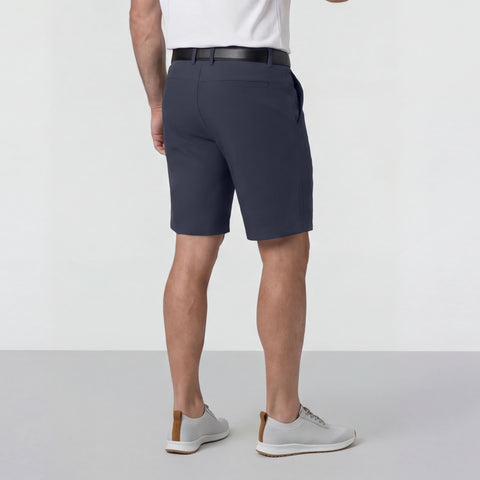 A man sitting wearing the Jetsetter Tech Short 9 inches in Deep Blue