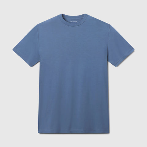 The Jetsetter Tee is a breathable blue short-sleeve crewneck shirt displayed flat on a white background.
