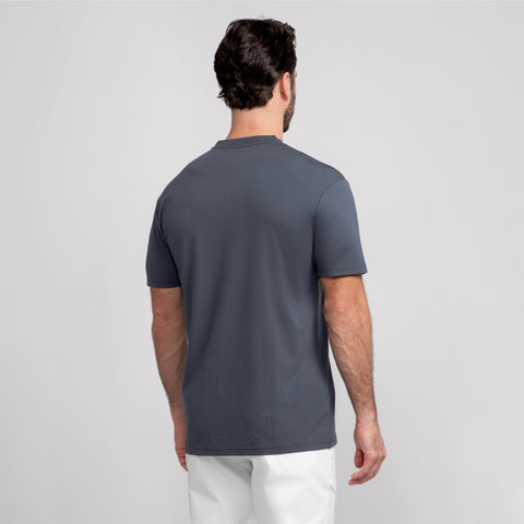 A man with short dark hair, seen from behind, wears the Jack Archer Jetsetter Tee in Charcoal Gray and white pants against a plain light gray background.