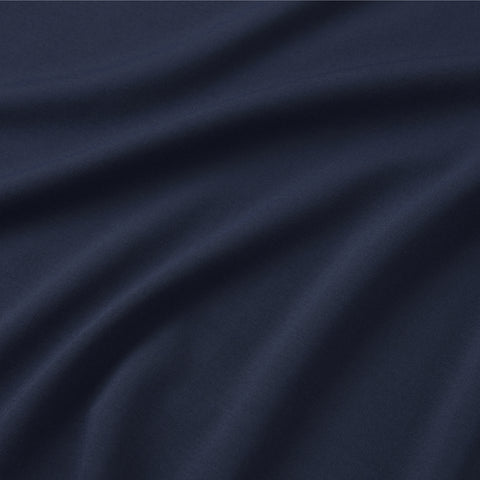 Close-up of the Jetsetter Tee -- Deep Blue by Jack Archer: smooth, deep blue fabric with flowing folds and soft shadows, highlighting its travel-ready crewneck style.