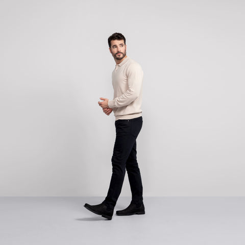 A man wearing the Legacy Polo Sweater in Beige.