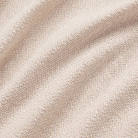 A man wearing the Legacy Polo Sweater in Beige, lifestyle detail.