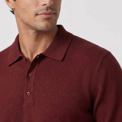 A man wearing the Legacy Resort Polo in Maroon, lifestyle setting.