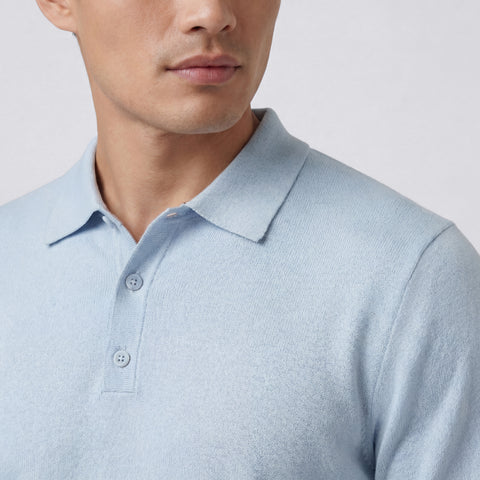 A man in the Legacy Resort Polo in Mist Blue outdoors
