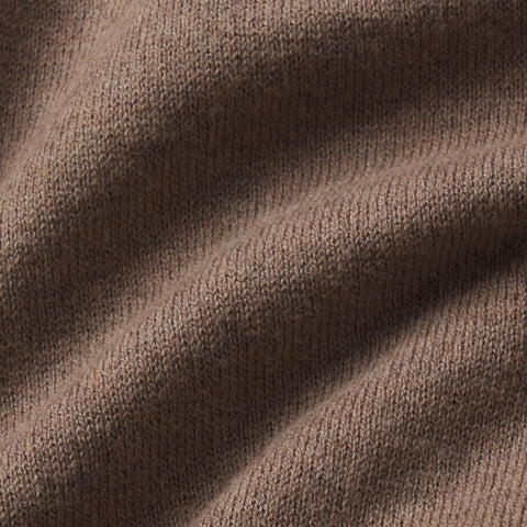 A man wearing the Legacy Resort Polo in Mocha Heather outdoors.