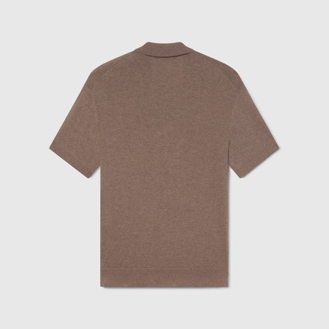 A man in the Legacy Resort Polo Mocha Heather, lifestyle setting.