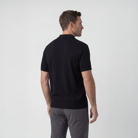 A man wearing the Legacy Resort Polo in True Black from behind.