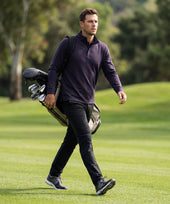 A man wearing the Sandwash Quarter-Zip in Deep Blue against a neutral background