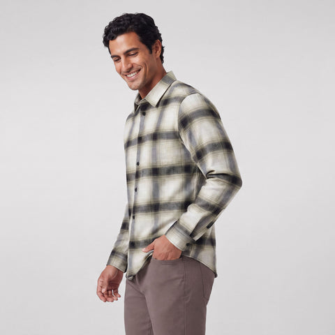 A man wearing the Anytime Plaid Shirt in Blackwatch Cream Plaid