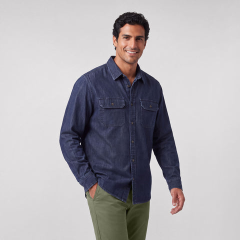 A dark wash chambray shirt with chest pockets, shown on a plain background.