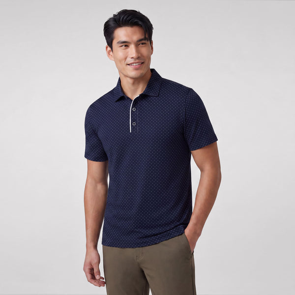 A man wearing Jack Archer Clubhouse Performance Polo in Navy Microdot against a light background.