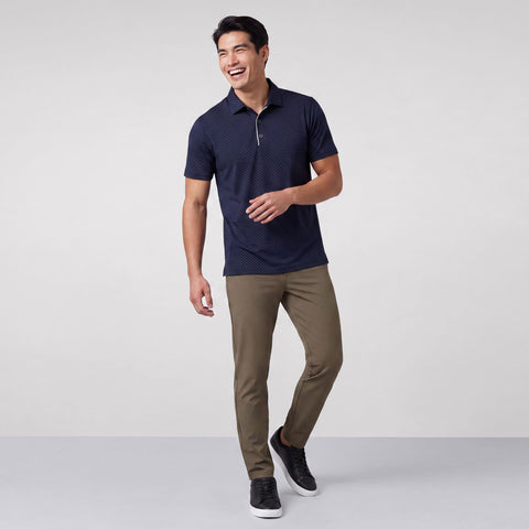 Alternate angle of a man in the Clubhouse Performance Polo, Navy Micro Dot