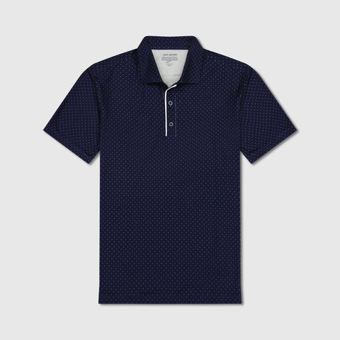 A man in the Clubhouse Performance Polo, Navy Micro Dot, seated