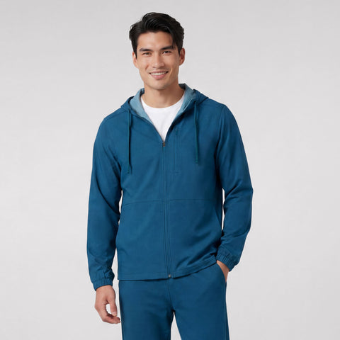 A man wearing the Clubhouse Range Hooded Jacket in Pacific Blue