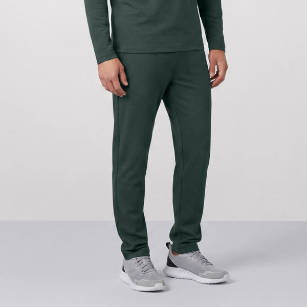 A man wearing the Clubhouse Range Jogger in Alpine Green