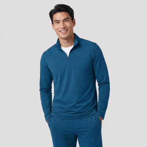 A man wearing the Clubhouse Range Quarter-Zip in Pacific Blue