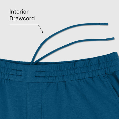 A man wearing the Clubhouse Range Short 7" in Pacific Blue outdoors