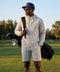 A man wearing the Clubhouse Range Short 7" in Vapor Gray in action