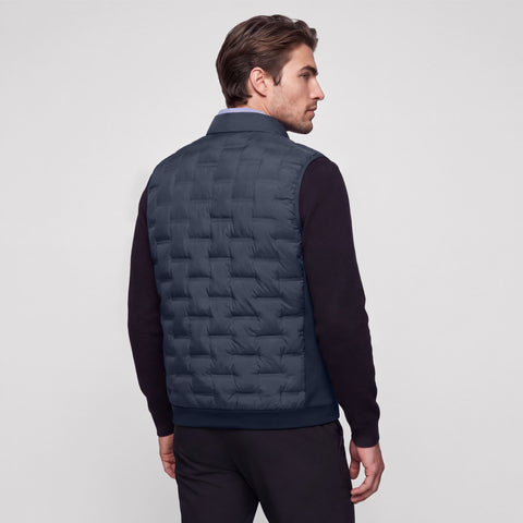Deep blue quilted Drive vest shown from the back on a model.