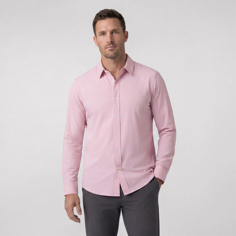 A man wearing the Everywear Shirt Shorter Length in Soft Rose with a classic button-down collar.