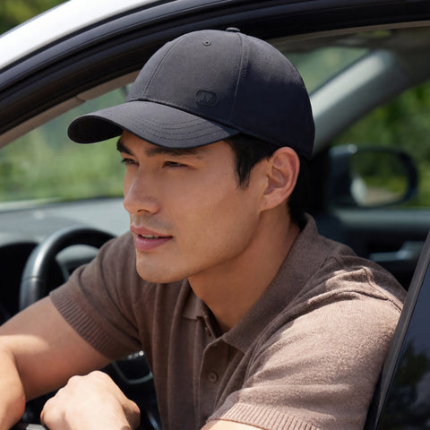 A man wearing the Club Performance Hat in Black on the golf course