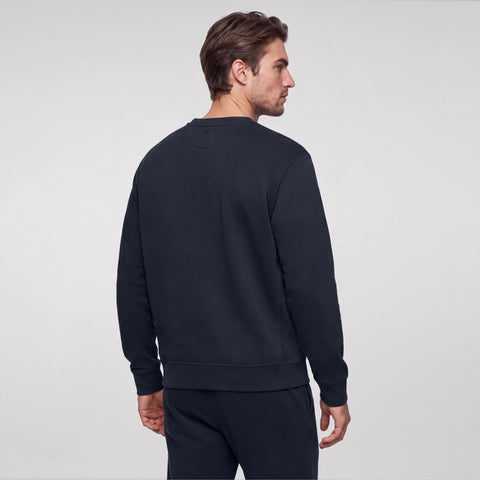 Midnight navy crewneck sweatshirt shown from the back, with matching sweatpants.