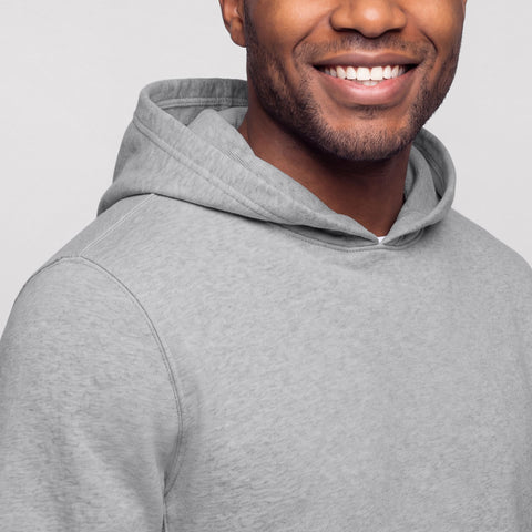 Close-up of a heather gray hooded sweatshirt showing the hood and shoulder seam.