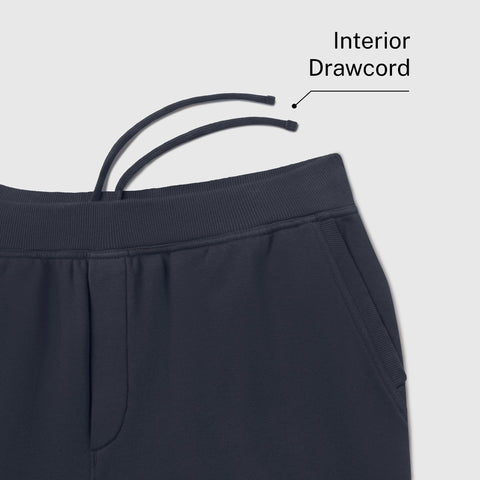 Close-up of the waistband on midnight navy sweatpants, labeled Interior Drawcord.