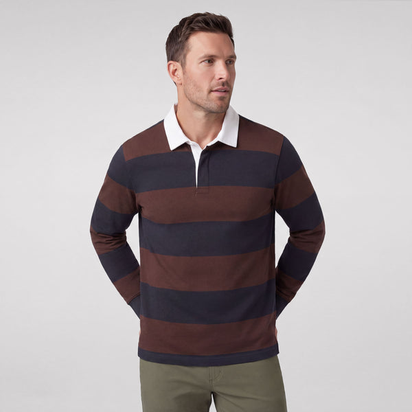 A man wearing the Rugby Polo in Chicory and Dark Navy