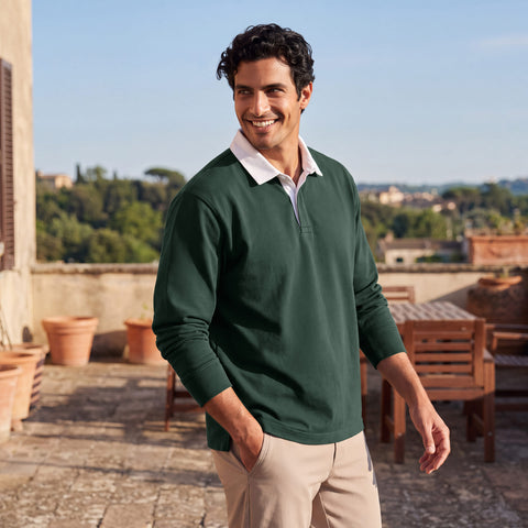 A dark green rugby polo with a white collar, worn with khaki chinos on a sunlit terrace.