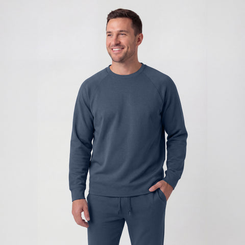A man wearing the Sandwash Crewneck in Tidal Blue