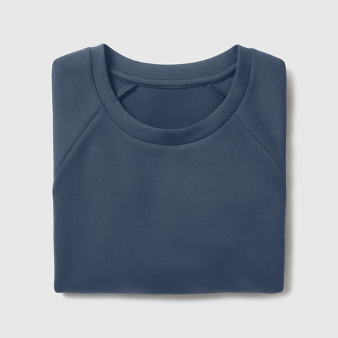 Man wearing the Sandwash Crewneck in Tidal Blue outdoors