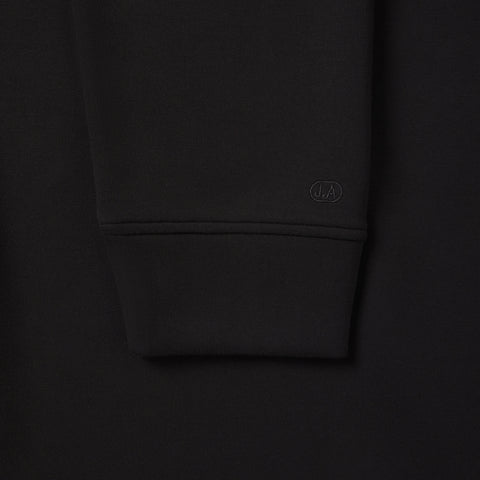 A man wearing the Sandwash Crewneck in True Black in everyday setting.