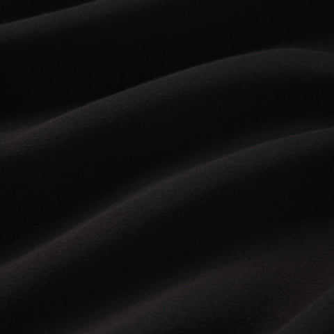 A man wearing the Sandwash Crewneck in True Black.