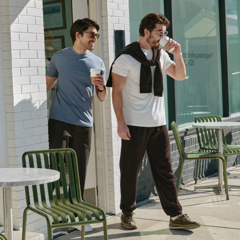 A man wearing the Sandwash Crewneck in True Black, seated in lifestyle.