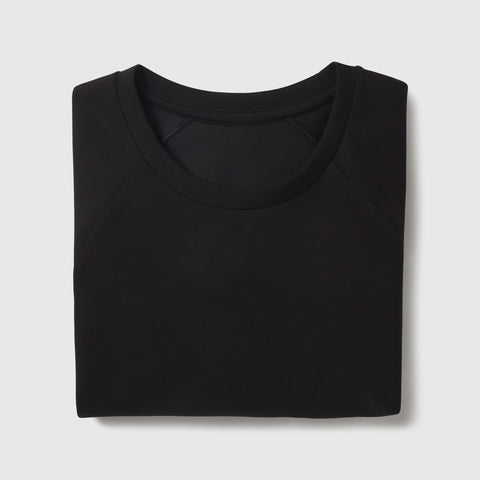 The Sandwash Crewneck in True Black, lifestyle detail of wearer.