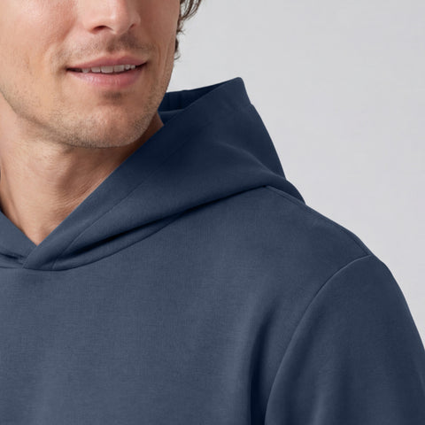 A man in the Sandwash Hoodie Tidal Blue in a casual lifestyle setting