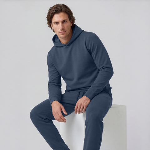 Man wearing the Sandwash Hoodie Tidal Blue in an outdoor environment