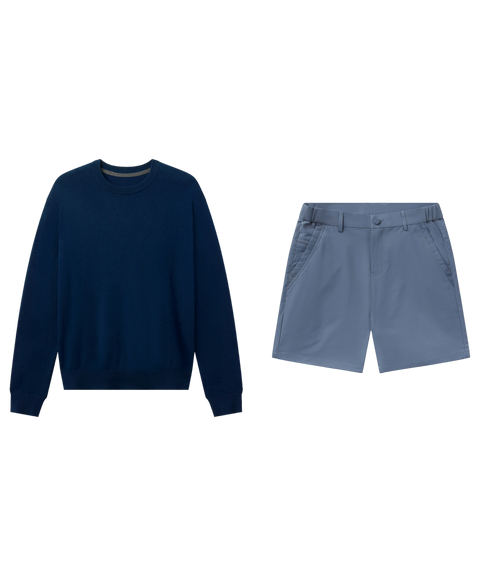 Navy crewneck sweater paired with slate blue flat-front shorts, shown flat.