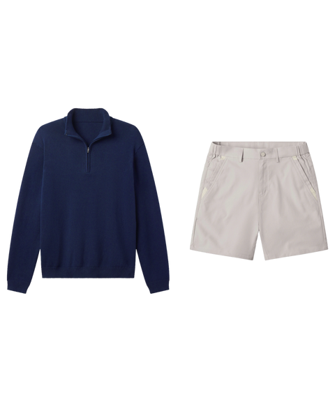 Navy quarter-zip knit pullover paired with light stone shorts, shown flat.