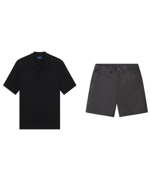 Black knit polo paired with charcoal grey flat-front shorts, shown flat.