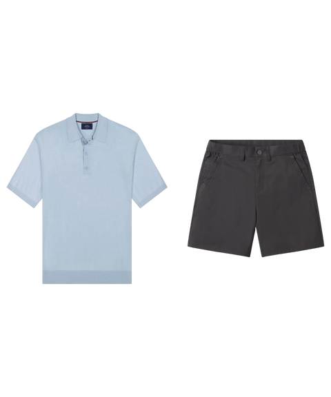 Light blue knit polo paired with dark charcoal shorts, shown flat.