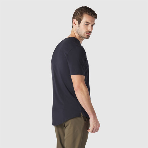 A man wearing the Anytime Tee in Deep Blue outdoors.